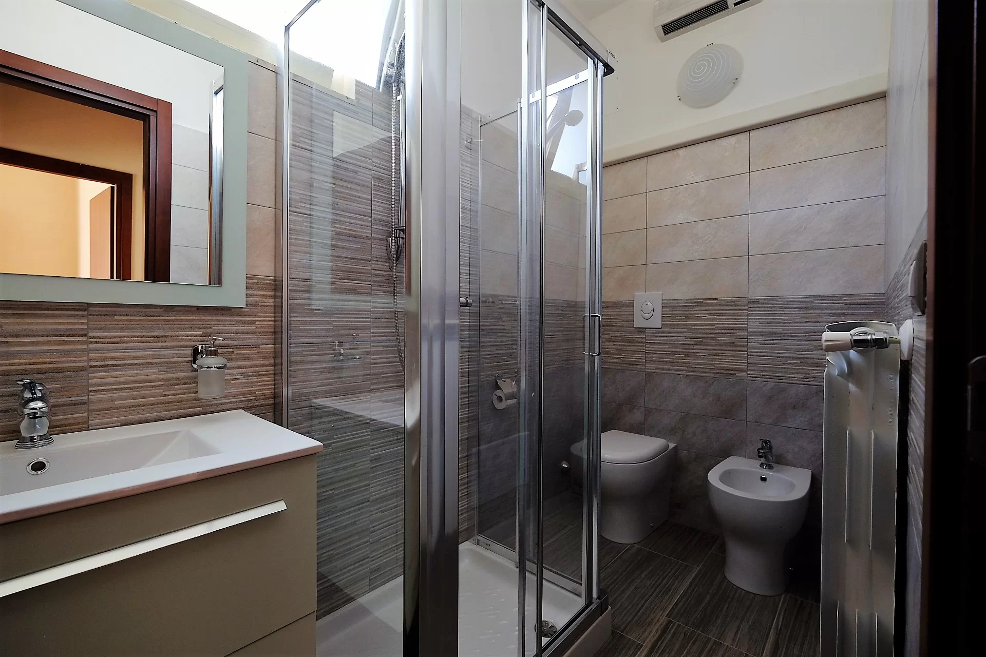 Bagno con specchio, lavandino, doccia, gabinetto e bidet Appartamento Pineto Vacanza Ginevra