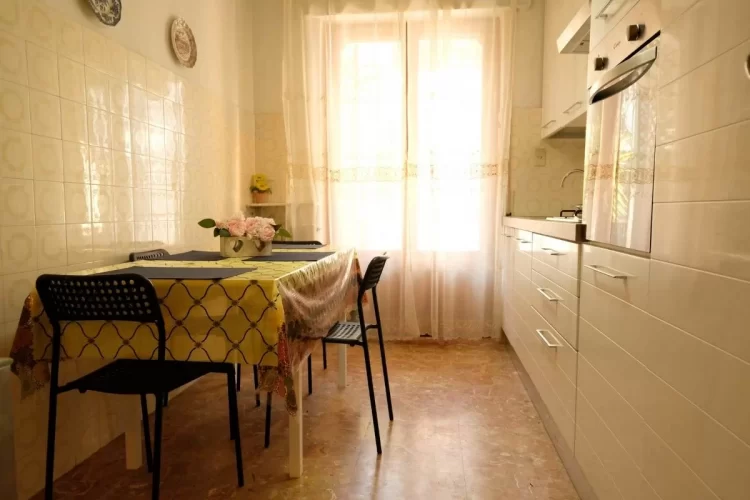Cucina bianca con tavolo e siede Appartamento Pineto Vacanza Malibù 5